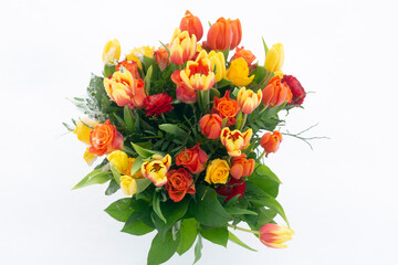 A bouquet of beautiful colourful tulips against a background of snow