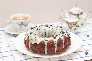 Round Easter homemade cupcake with white icing. Freshly baked homemade protein cream cake, tea set, milk and a cup of cappuccino