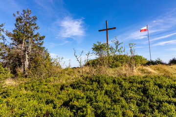 Fototapeta na wymiar Memorial cross on top of Leskowiec peak in Little Beskids mountains near Andrychow in Lesser Poland