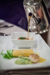 soup poured into the bowl at the fine dining restaurant. High quality photo