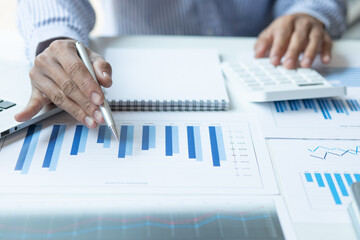 Financial Businessman analyze the graph of the company's performance to create profits and growth,...