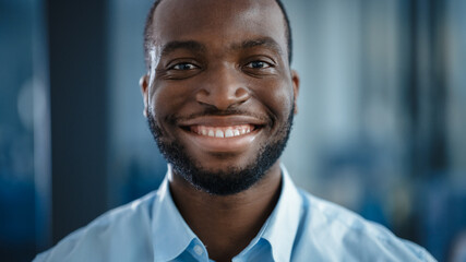 Close Up Portrait of a Black African American Handsome Male in a Light Blue Casual Shirt....