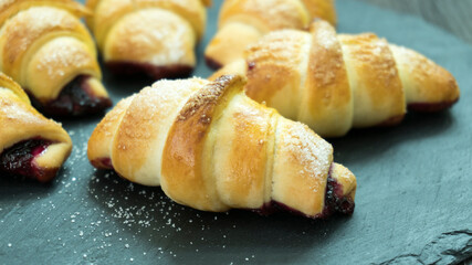 Fresh homemade croissants on stone table
