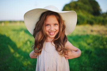 little girl in linen dress in countryside
