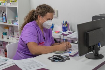 Female veterinarian working at the office with the computer