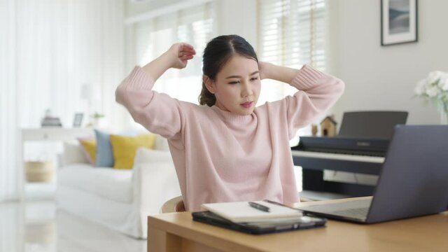 Attractive beautiful young asia female feel tired overworked negative impact health life stretching for break time relax stress relief in concept problem work remotely from home or burnout syndrome.