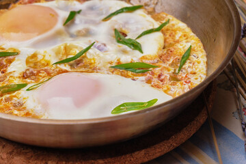Scrambled eggs with onion and chives served with bread