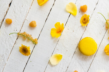 Yellow macarons on a white background with yellow flowers
