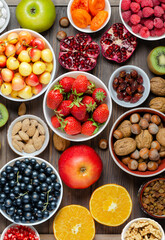 Mix of fresh berries, nuts and fruits. Healthy food contains a lot of vitamins and useful trace...