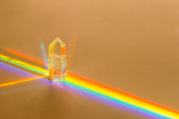 Healing chakra crystal and rainbow on beige background. Meditation, reiki and spiritual healing concept