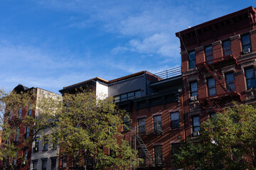 Row of Colorful Old Residential Buildings in the East Village of New York City with Fire Escapes