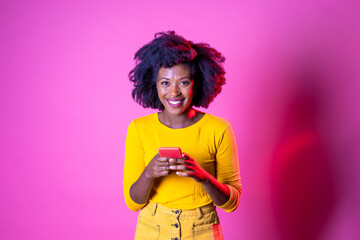 Young beautiful black woman texting smartphone