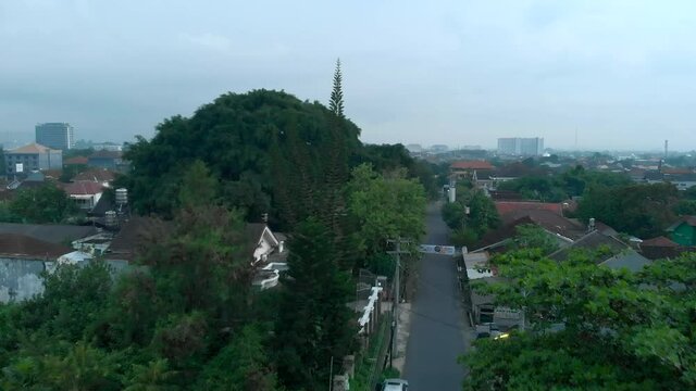 Aerial landscape view of local neighbourhood in Yogyakarta city, Indonesia with green trees and small road