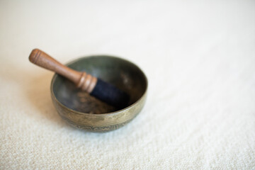 Singing bowl or Tibetan bowl and wooden mallet or stick for meditation, mindfulness, sound healing, relaxation. 