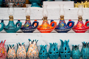 Fototapeta premium Traditional handmade kerosene lamps, vases and candle holders sold in front of the store.