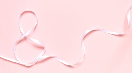 Number eight made of white ribbon on pink background. Card for 8 March, woman day. Copy space, mock up, banner.