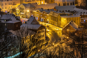 View of the illuminated, snow-covered old town in Oliwa. Gdansk, Poland. - obrazy, fototapety, plakaty