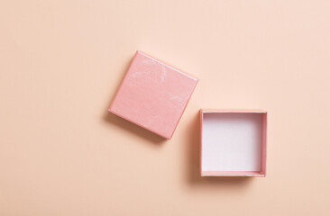 open pink box on pastel paper background