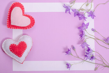 Valentines day card with copy space, white frame on lilac background with hearts and flowers