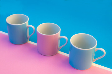 Pink and blue coffee cups on coloured background ,graphic image with bright colours.