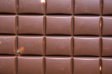 close-up of  milk chocolate bar with hazelnuts