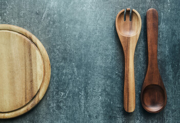 Wooden spoons and cutting board, kitchen utensils, vintage style. Top view