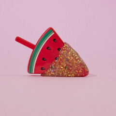 Watermelon ice cream tooped with slime on a pink background