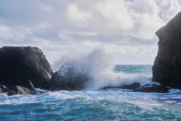 stormy surf with splashes among coastal rocks