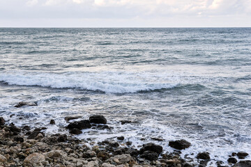 stony coast of the winter sea on a cloudy day