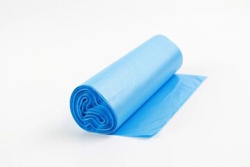 Roll of blue plastic bag for garbage and waste. A mock-up of a new, unused plastic garbage bag on a white background. The concept of waste disposal.