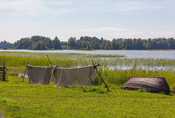 Fishihg nets and old wooden boat on the bank of Onega lake on the Kizhi island, Karelia, Russia