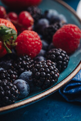 Healthy breakfast eating a mix of fresh berries fruits