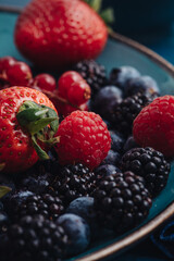Healthy breakfast eating a mix of fresh berries fruits