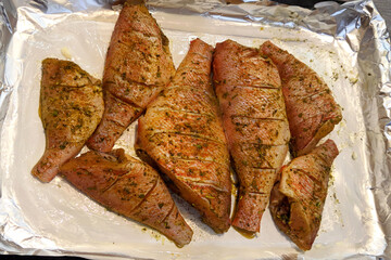 Marinated pieces of sea fish on foil
