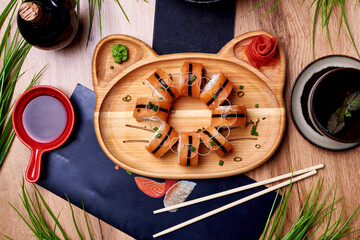 japanese rolls, sushi with sauce on a wooden table