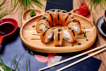 japanese rolls, sushi with sauce on a wooden table