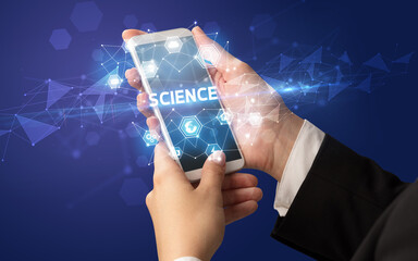 Female hand holding smartphone with SCIENCE inscription, modern technology concept