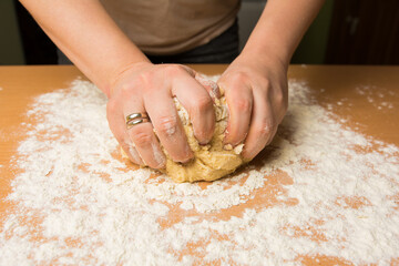 Female hands making dough for baking or bread.