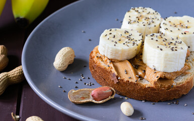 fast food, snack, peanut butter and banana sandwich with chia seeds on a plate