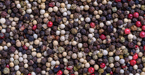 A spread of an assortment of peppercorns as a background