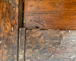 weathered natural wooden structure closeup, brown background