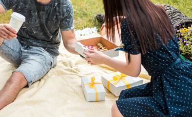 Couple treat each other with traditional French dessert eclairs or profiteroles. A young couple...