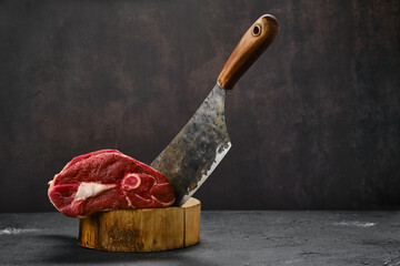 Raw lamb leg and butcher cleaver