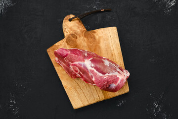 Overhead view of raw lamb rump on cutting board © boomeart