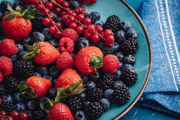 Healthy breakfast eating a mix of fresh berries fruits
