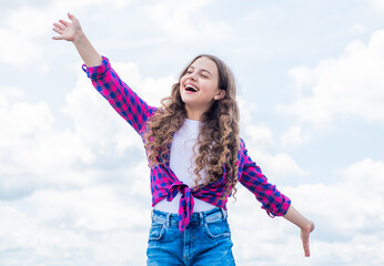 Pure beauty. concept of future. happy childhood. cheerful teen girl has long curly hair. kid smiling outdoor. kid fashion and beauty. sense of freedom. portrait of pretty child girl