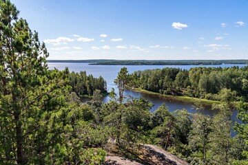 Fototapeta na wymiar Russia, Lake Ladoga, August 2020. Skerries of the lake shore, view from the cliff.