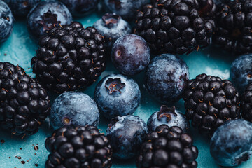 Healthy breakfast eating a mix of blueberries and blackberries