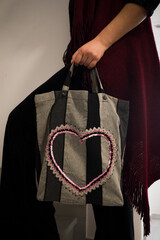 Woman's hand holding a fabric tote bag