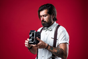 brutal guy photographer wear bow tie. elegant male hold retro camera. handsome hipster making...